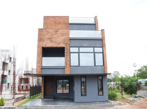 Casagrand Hanford building exterior with brick and grey finish in Mamidpally